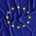 A close-up image of the European Union flag, showing its blue background with a circle of yellow stars.
