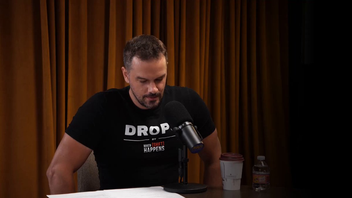 The image features a man sitting at a table, wearing a black t-shirt that says "DROPS E39: @NassDiba studied quantum physics, worked at Facebook, then left to build in crypto. He' s now building Worm - a permissionless prediction market on Solana with leverage. His thesis: prediction markets are the only mechanism". The man is sitting behind a microphone and there's a cup of coffee next to him on the table.