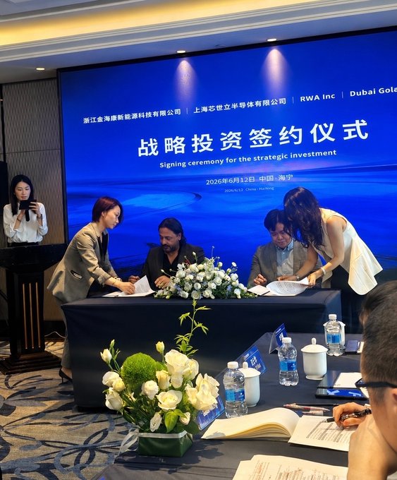 Executives sign a strategic investment agreement at a ceremony held June 12, 2026, in Haining, China, between Zhejiang Jinhai New Energy Materials Co., Ltd. and Shanghai Cishi Lixing Semi-Conductor Co., Ltd., with RWA Inc and Dubai Gole also listed on the backdrop as partners in the new-energy mobility asset tokenization deal.