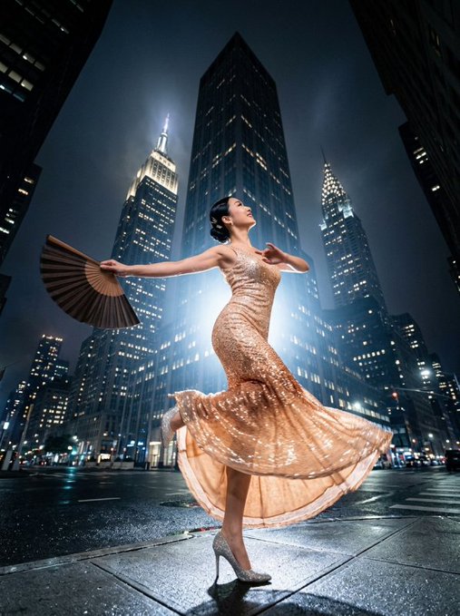 A graceful dancer in a shimmering gold sequin gown twirls with a hand fan amid a moonlit urban skyline, her flowing dress and poised stance embodying the "golden elegance" described in the post, while the towering skyscrapers behind her evoke the fusion of city life and transcendent artistry referenced in the "Cosmic Consciousness Studies" theme.