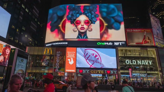 A vibrant digital billboard in Times Square displays an NFT-themed artwork of a woman with afro hair and red sunglasses, along with visible signage for "OLD NAVY," "McDonald's," "Yankees," "papeys," "I ♥ NY GIFTS," and "OneHub NFT," promoting the NFT NYC 2026 Community Artist Showcase open call.