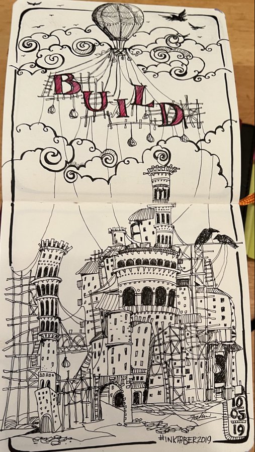A detailed pen-and-ink sketch in a moleskine notebook featuring the word 'BUILD' with a hot air balloon and an elaborate castle with scaffolding, signed '#INKTOBER2019'.
