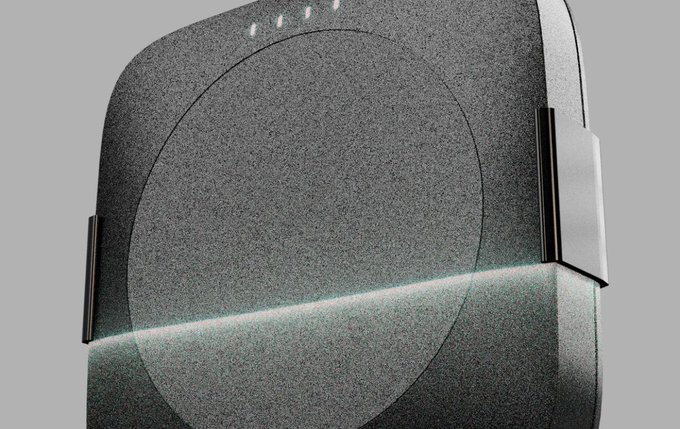 A close-up product render of a dark grey textured wireless charger or smart speaker with indicator lights on top and a glowing base edge.