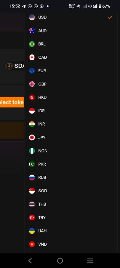 A mobile screenshot displays a currency selection dropdown menu with options including USD (selected with an orange checkmark), AUD, BRL, CAD, EUR, GBP, HKD, IDR, INR, JPY, NGN, PKR, RUB, SGD, THB, TRY, UAH, and VND, each accompanied by their respective country flags. The accompanying post references Sidra-related accounts and appears unrelated to the currency selection screenshot shown.