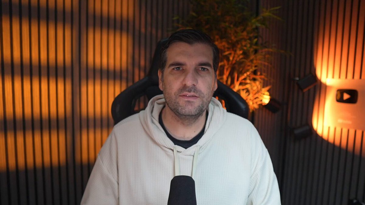 The image shows a man wearing a white hoodie sitting in front of a computer screen with his eyes closed, giving him an intense look as if he's contemplating something or taking a break from work. The background features a wooden wall with lights behind him, creating a warm and cozy atmosphere. There is also a plant visible on the right side of the image.

The post seems to be discussing a recent acquisition made by Hadera, a company that specializes in blockchain technology. They have purchased their biggest competitor's intellectual property, which has the potential to change the landscape of the blockchain industry. The man sitting in front of the computer screen appears to be contemplating this development or taking a break from his work related to the acquisition.