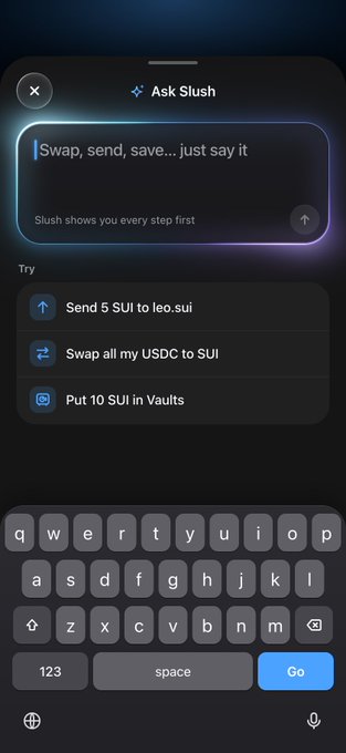 A mobile wallet interface displays an "Ask Slush" AI prompt box with the placeholder text "Swap, send, save...just say it" and a note that "Slush shows you every step first," along with suggested commands like "Send 5 SUI to leo.sui," "Swap all my USDC to SUI," and "Put 10 SUI in Vaults." The image illustrates the user-facing entry point of Slush Wallet's AI agent, showing how natural language commands can be entered to initiate crypto transactions directly from a text input.