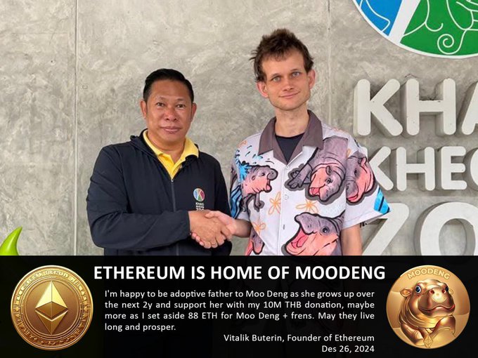 The image features two men standing next to each other, with one man wearing a shirt that has "Moodeng" written on it. The other man is shaking hands with the first man. They are both smiling at the camera. In front of them, there's a sign that says "Ethereum is home of moodeng". This suggests that they might be discussing or promoting the concept of using Ethereum to create and manage digital assets, such as cryptocurrencies or smart contracts. The image also includes two gold coins placed on either side of the men, which could represent the value or importance of the cryptocurrency or blockchain technology being discussed in their conversation.