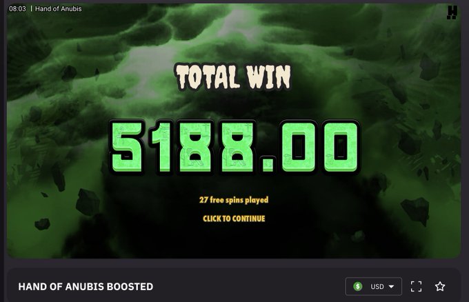 The image features a casino game screen showing the total win amount with $5,000 displayed at the bottom of the page. Below this information, there's another image of a friend who has just hit a 2,700x on Hand of Anubis, with the words "Hand of Anubis" written above it. The text suggests that their luck was certainly boosted by using code that says "HERRO' for increased luck." It appears to be an advertisement for a new casino game or feature on the website.