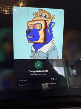 A tablet screen displays a confirmation message reading 'Congratulations! #515 is now yours' with a price paid of 119 ETH for a blue bear NFT character.