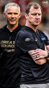 SMU head coach Rhett Lashlee, in a black shirt with arms crossed, stands alongside a Florida State Seminoles coach wearing a black "FLORIDA STATE SEMINOLES" shirt. The image accompanies coverage of Lashlee's comments ahead of SMU's matchup against Mike Norvell's Florida State team, with the Mustangs favored by 3.5 points.