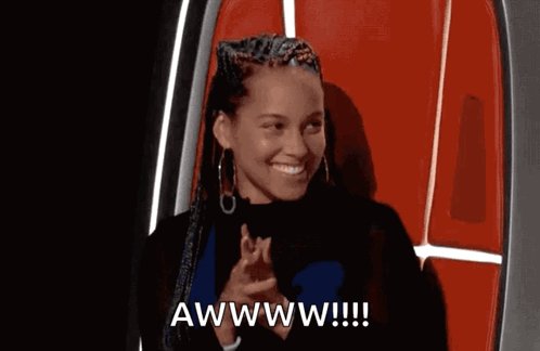The image features a woman with dreadlocks wearing a black shirt, sitting against a red wall or door frame. She has her hands together and appears to be clapping her hands. The caption below the photo reads "yesss bayc no doubt lol".