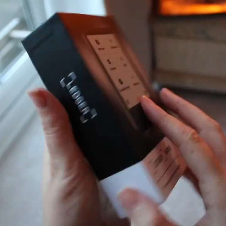A close-up shot shows hands unboxing a Ledger Nano Gen5, with the device's sleek screen displaying the Ledger logo, matching the post's excitement about upgrading to the newest hardware wallet. The minimalist packaging and modern design reflect the seamless experience of setting up the new device with the Ledger Wallet app.
