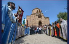 A religious ceremony takes place outside an Armenian church, with clergy in traditional vestments holding ceremonial banners and staffs. The gathering appears connected to the post's discussion of crypto-Armenians—families in Diyarbakır who were forcibly converted to Islam, some later reconnecting with their Armenian Christian heritage, as symbolized by the church setting.