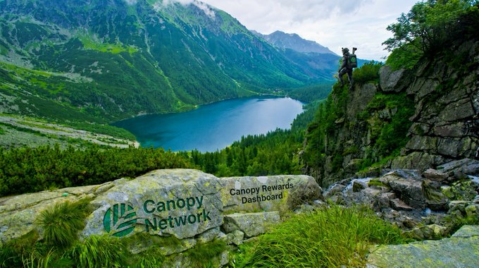 A scenic mountain landscape features a turquoise lake and a hiker on a rocky outcrop, with overlay text reading "Canopy Network" and "Canopy Rewards Dashboard" beside a green leaf logo.
