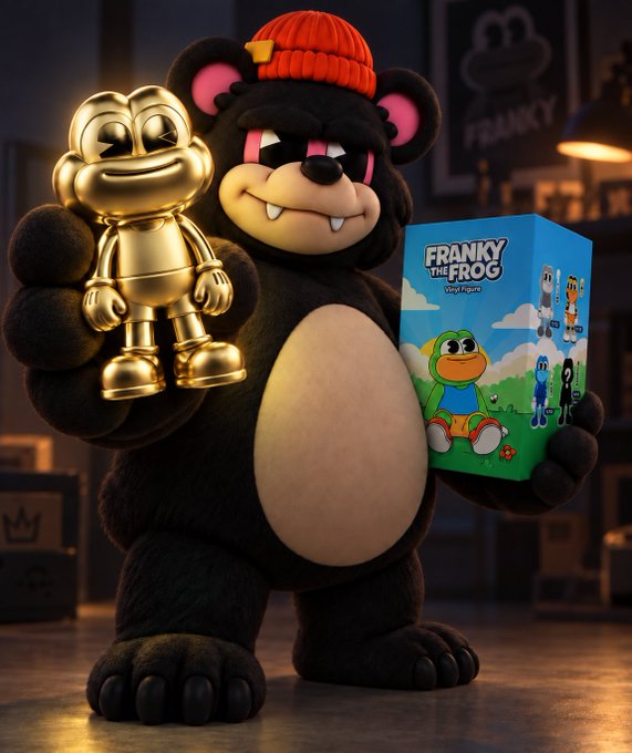 A 3D rendered black bear character wearing an orange beanie holds a golden figure in one paw and a "Franky the Frog" vinyl figure box in the other.
