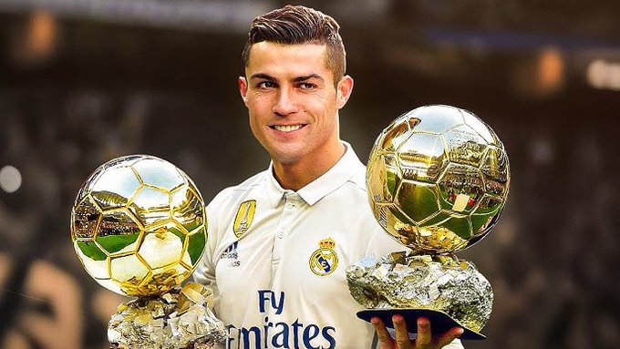 Cristiano Ronaldo proudly displays two golden Ballon d'Or trophies while wearing a Real Madrid jersey featuring the "Fly Emirates" sponsor and club crest. The image cleverly illustrates the "before vs. after" meme concept—showing a triumphant, successful version of the trader that the poster aspires to become after successfully navigating perpetual futures trading.