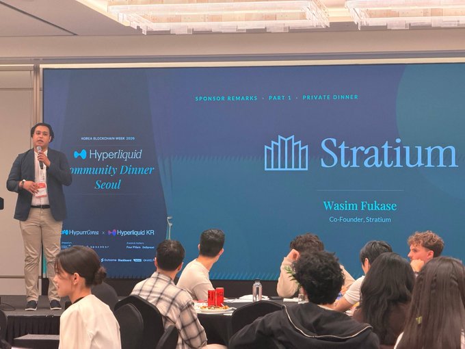 A photo from the Korea Blockchain Week 2025 Hyperliquid Community Dinner Seoul, showing a man speaking on stage with a screen displaying "SPONSOR REMARKS - PART 1 - PRIVATE DINNER" and "Stratium - Wasim Fukase, Co-Founder, Stratium" with an audience seated in front.