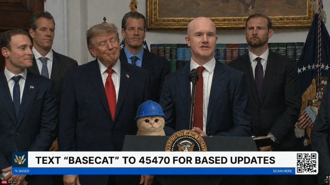 A government official speaks at a podium during what appears to be a press briefing, with former President Donald Trump and other officials standing behind him, while a stuffed cat wearing a blue hard hat sits on the podium. The image includes an on-screen banner reading "TEXT 'BASECAT' TO 45470 FOR BASED UPDATES" alongside the "@BASED" branding and a QR code, tying into the $BASECAT meme token referenced in the post about "hearing some based things."