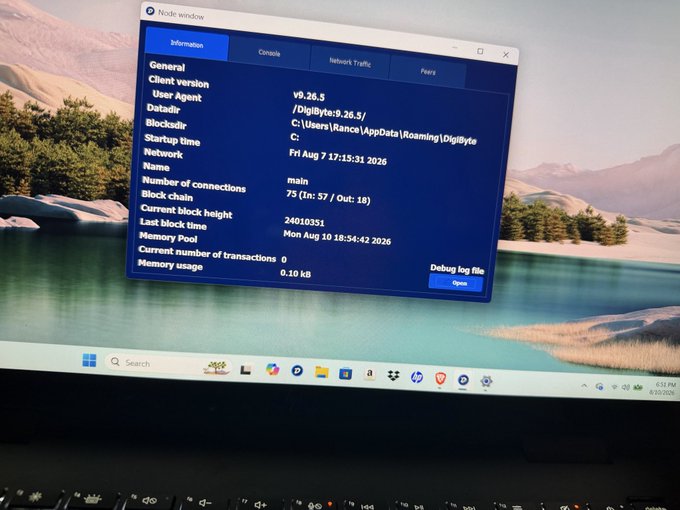 A laptop screen displays a Node window for version 9.26.5 of what appears to be DigiByte software, showing network status and startup time information.