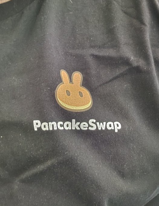 A black hoodie featuring the PancakeSwap logo with the brand name printed in white text below the bunny mascot.