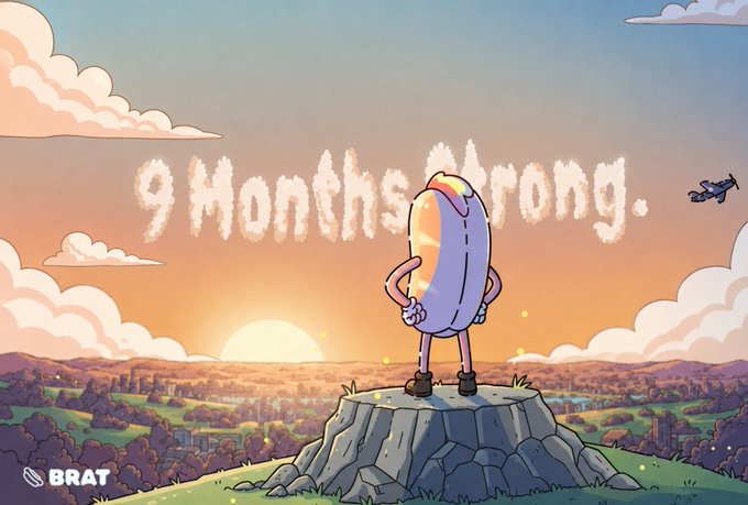 A cartoon hot dog character with sunglasses stands triumphantly on a rock overlooking a sunset landscape, with the cloud-text phrase '9 Months Strong.' displayed in the sky and a 'BRAT' logo in the bottom left corner.