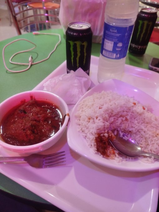 A meal tray featuring a bowl of red curry or stew alongside a plate of white rice, accompanied by two cans of Monster energy drink and a bottle of Aqua water, sits on a green table.

The image of a casual meal with energy drinks doesn't appear to relate to the post's content about Web3 development and Tria's product-building approach.