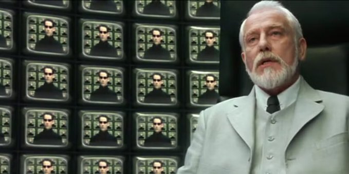 The image shows a wall of multiple TV screens displaying the same image of Neo from The Matrix, with an older bearded man in a white suit (resembling the Architect from the film) standing to the right. The accompanying post humorously uses this iconic scene to suggest that avoiding Solana-based meme coins during Hyperliquid meme seasons is the only way to navigate the recurring cycle successfully, playing on the film's themes of prediction and pattern recognition.