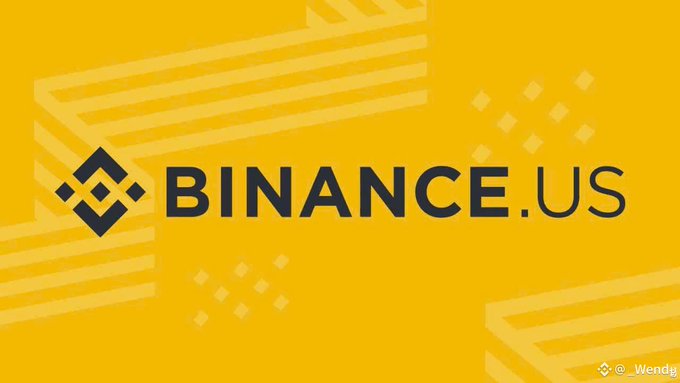 Binance.US logo banner with the text "BINANCE.US" in bold black lettering on a yellow background, visually supporting the announcement of Velo Protocol's (@veloprotocol) listing on the Binance.US platform.