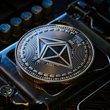 A close-up of an Ethereum coin engraved with the triangular Ethereum logo, resting on a computer motherboard. It illustrates the report that core developers postponed the Oct. 26 Glamsterdam upgrade on the Hoodi testnet to investigate EIP-8037’s interaction with mainnet smart contracts.