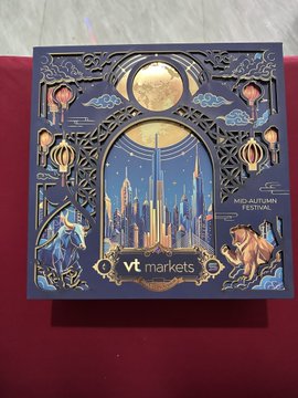 An ornate metallic card or plaque for 'VT markets' displays 'MALDIVIAN FESTIVAL' with an illustrated cityscape, moon, lanterns, and mythical creatures.