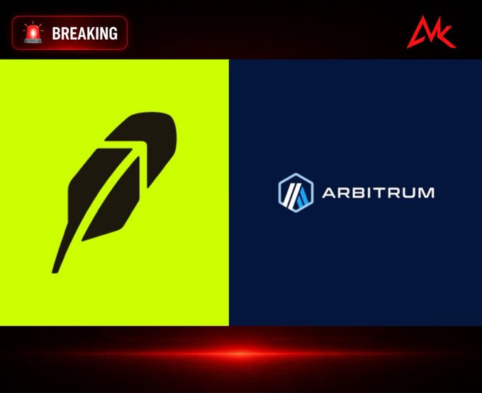 A breaking news-style graphic with a red siren 'BREAKING' tag and an MK logo, showing the Robinhood feather logo on a green background on the left and the Arbitrum logo on a dark blue background on the right.