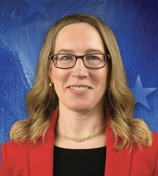 A portrait shows SEC Commissioner Hester Peirce wearing glasses, a red blazer, and gold necklace against a blue backdrop with star motifs, accompanying news that she commented on crypto vaults and onchain lending strategies potentially falling under federal securities laws.