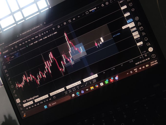 A laptop screen displays a TradingView chart of 4902.TOSEI.T trading on Japan Exchange with red candlestick patterns visible.
