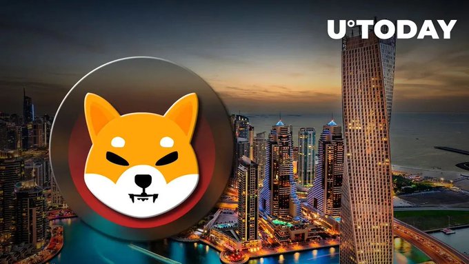 A Shiba Inu logo is superimposed over a Dubai cityscape at dusk, with the "U°TODAY" watermark in the top right, illustrating the news of Emirates Airlines accepting SHIB and 29 other cryptocurrencies for flight bookings.