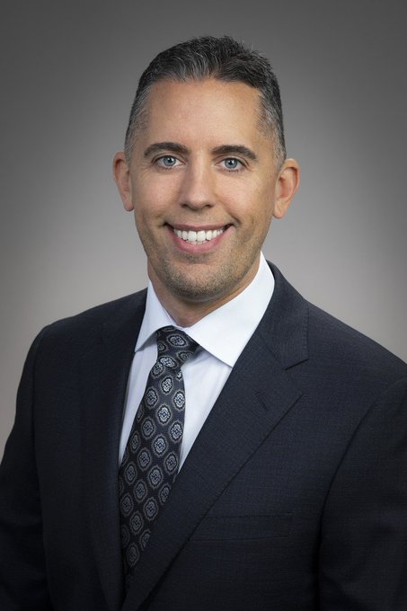 A professional headshot features a smiling man with short graying hair, wearing a dark suit, white shirt, and a dark patterned tie against a gray background. The image accompanies a post about Strive CEO Matt Cole discussing the company's potential acquisition of over 20,000 $BTC by year-end.