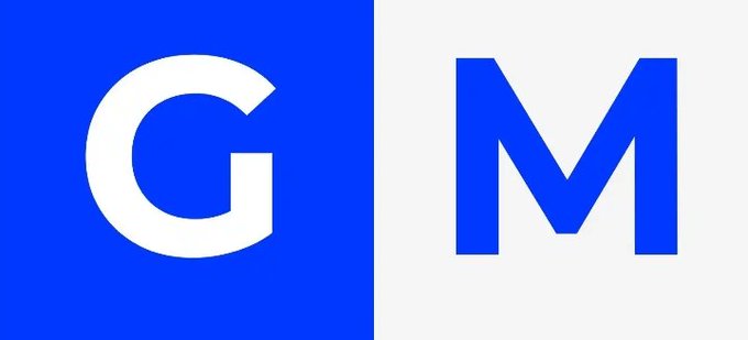 The image features a logo with two blue squares and a white "M" inside them. The text "G" appears above the "M", while the word "M" is positioned below the "G". This design choice creates an interesting visual contrast between the blue and white elements, making it stand out against a gray background.