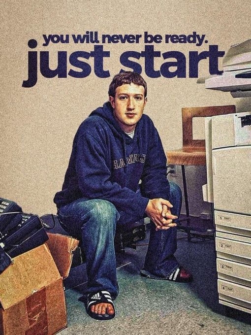 A young man in a blue Harvard hoodie and sandals sits casually among cardboard boxes and filing cabinets, with the motivational text "you will never be ready. just start." overlaid above him—fitting for a "gm" post as it encourages embracing the imperfect beginning of any new day or endeavor.