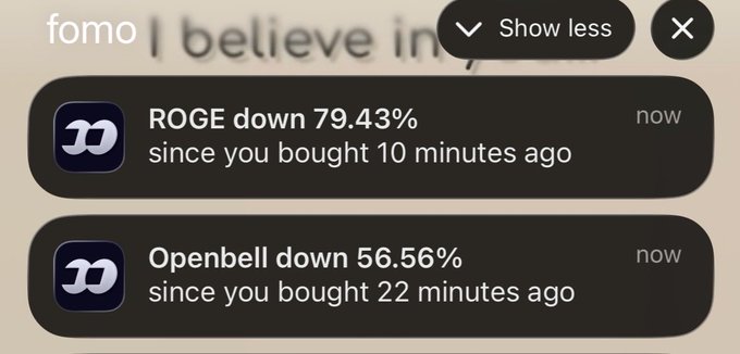A crypto trading notification shows alarming price drops for two assets since purchase: **ROGE down 79.43%** (bought 10 minutes ago) and **Openbell down 56.56%** (bought 22 minutes ago). The post's caption highlights the anxiety of receiving such devastating loss alerts shortly after buying.