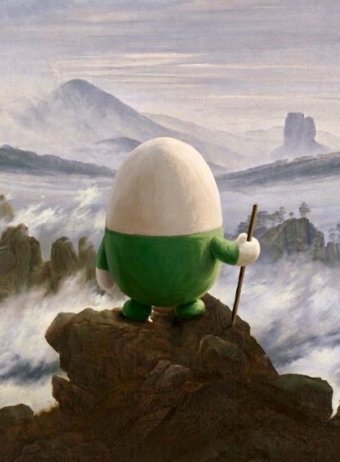 A figure with a green body and a cracked egg for a head stands on a rocky peak holding a staff, set against a misty landscape painting reminiscent of Caspar David Friedrich's 'Wanderer above the Sea of Fog'.