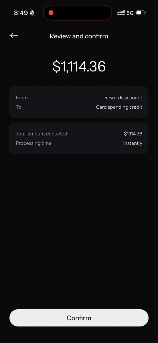A mobile phone screenshot of a 'Review and confirm' screen showing a transaction of $1,114.36 transferring from a 'Rewards account' to 'Card spending credit', with instant processing time and a 'Confirm' button at the bottom.