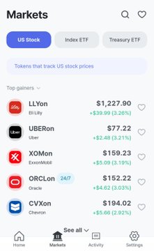 A mobile app Markets screen displaying top gainers among US stock tokens, including LLYon at $1,227.90 (+3.26%), UBEron at $77.22 (+3.21%), and XOMon at $159.23 (+3.19%).