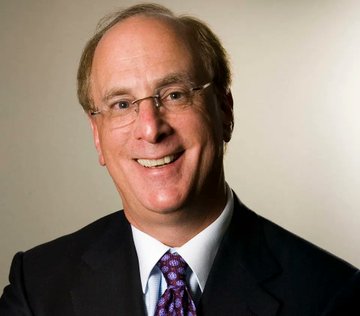 A smiling older man with glasses, wearing a dark suit and a patterned tie, poses for a professional portrait. The image likely represents Larry Fink, CEO of BlackRock, whose firm is highlighted in the post for acquiring significant Bitcoin through its IBIT ETF, reflecting the growing institutional demand for Bitcoin.