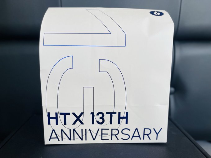 A white box displays a large outlined number '13' and the text 'HTX 13TH ANNIVERSARY' on its side.