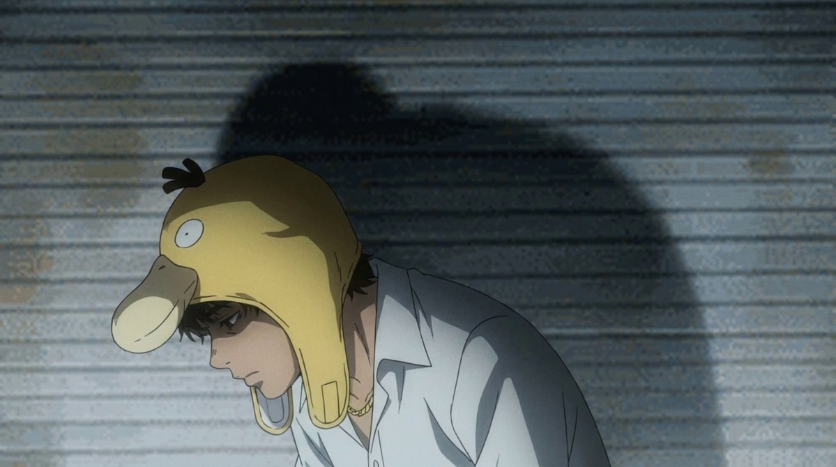 A man wearing a yellow duck hat and an orange shirt with gold earrings is holding onto something, possibly a trading support or the trading system. The caption above him suggests that he could be trying to trade more TRIA tokens, which indicates the connection between the image of the man in the hat and his trading actions in the market.