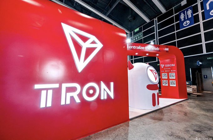 The image features a striking red booth with "TRON" prominently displayed in large letters at its center, set against a black background. The booth also has some text written above it that reads "Central bank of Vietnam", which provides additional context about the business being showcased at this trade show or event.