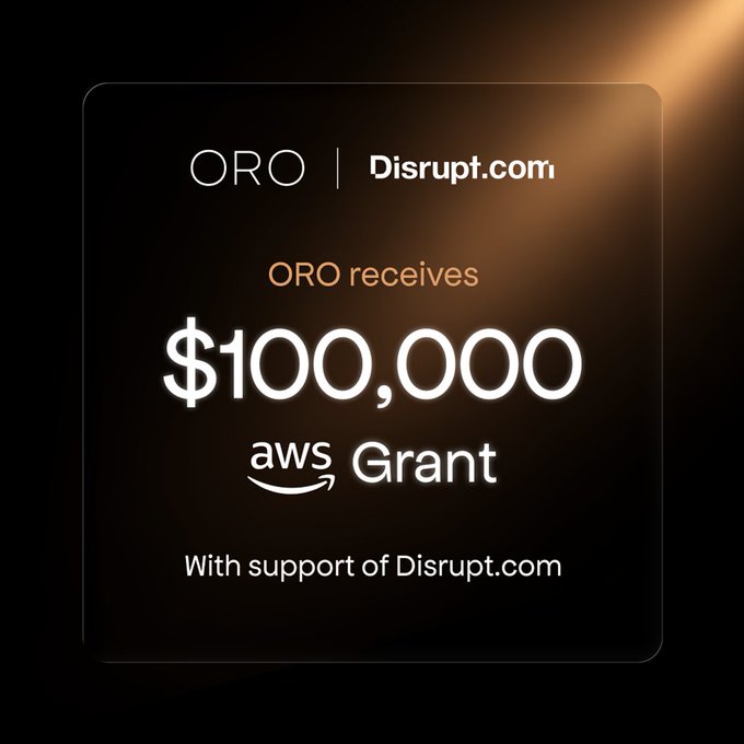 A promotional graphic announces 'ORO receives $100,000 aws Grant With support of Disrupt.com', featuring logos for ORO and Disrupt.com against a dark background with gold lighting.