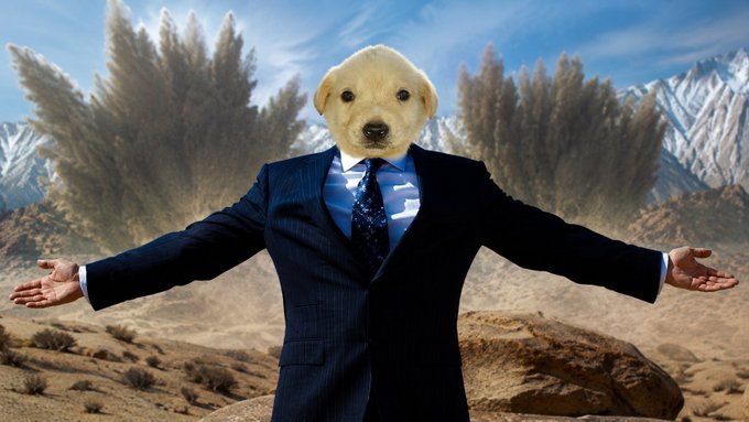 A golden retriever puppy wearing a pinstripe business suit and tie stands with arms outstretched in a desert landscape with mountains, embodying a confident and welcoming "gm" (good morning) greeting to start the new week.