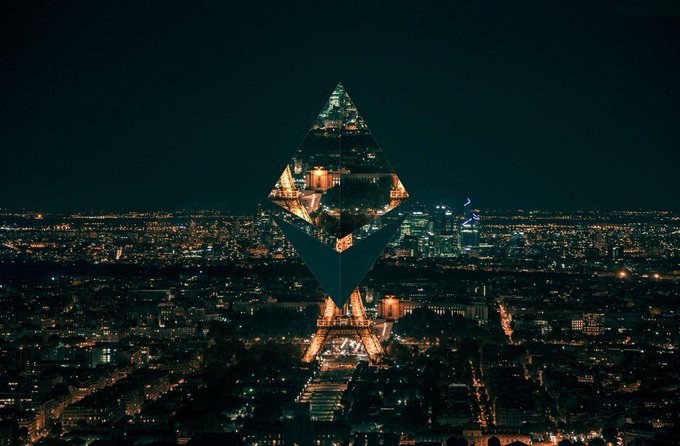A creative nighttime composite photograph of Paris featuring the Eiffel Tower overlaid with a glowing, translucent Ethereum diamond logo, surrounded by the city's illuminated skyline.