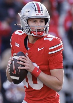 Ohio State quarterback Will Howard, wearing his #10 red jersey, looks downfield while gripping a football during a game, illustrating the team's strong odds to beat Texas and secure a big payday for a bettor.
