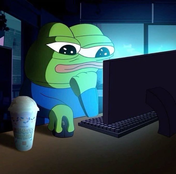 A melancholic cartoon image of a sad green frog (Sad Frog/Pepe) sitting at a computer desk with a coffee cup, staring at a monitor.